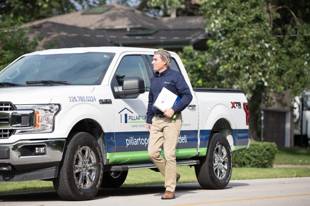 Home Inspector walking away from truck