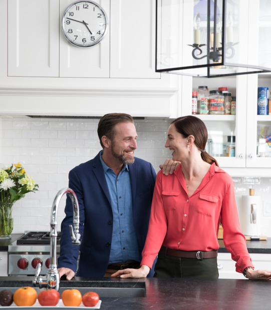 homeowners smiling in the kitchen