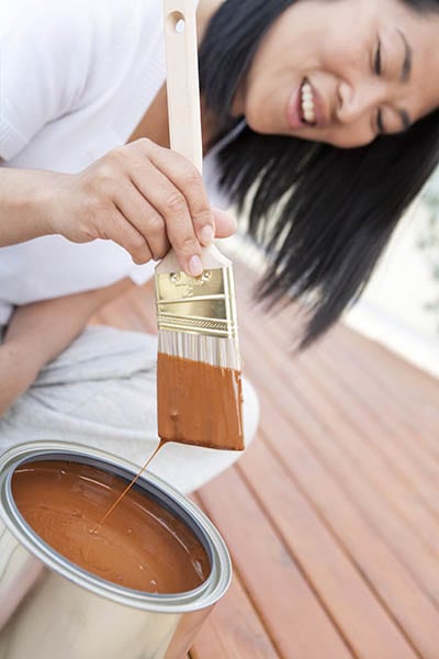 Woman painting the deck